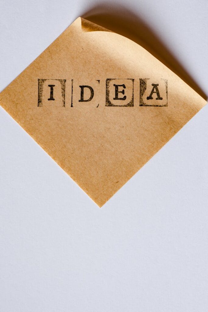 Minimalist close-up of a note with 'Idea' stamped on it, featuring a rustic aesthetic.